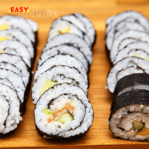 Plateau de sushis maison, avec makis et nigiris, joliment présentés sur une assiette.