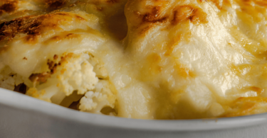 Gratin de chou-fleur doré, servi dans un plat gratiné avec une belle croûte au fromage.