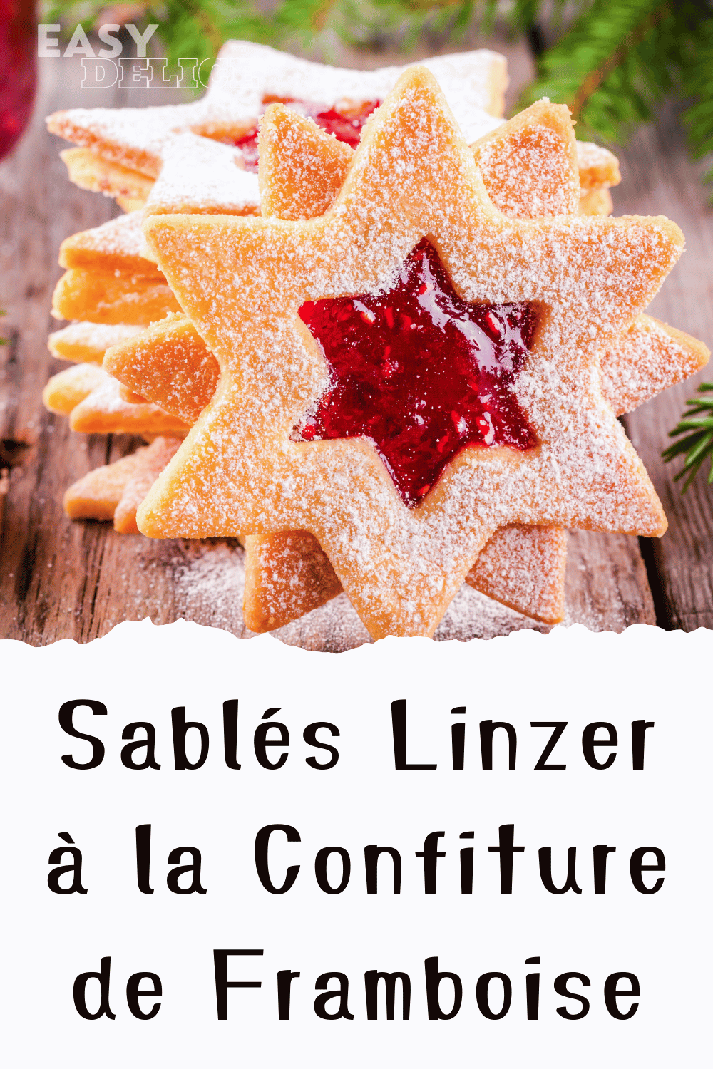 Sablés Linzer garnis de confiture de framboise, saupoudrés de sucre glace sur une assiette festive.