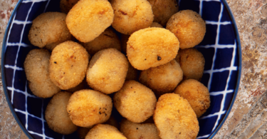 Nuggets de pois chiches croustillants et dorés, servis avec une sauce crémeuse et des légumes frais