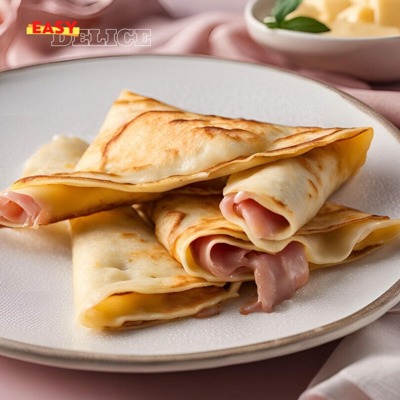 Crêpes au jambon et béchamel croustillantes, servies dorées sur une assiette, accompagnées d’une salade verte.