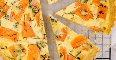 Quiche saumon brocoli dorée et appétissante, prête à être servie avec une salade verte.