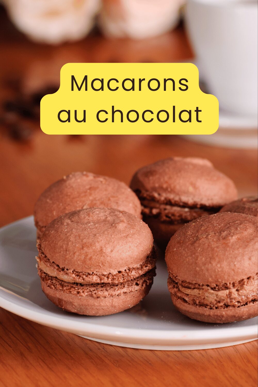 Macarons au chocolat avec ganache brillante empilés sur une assiette blanche